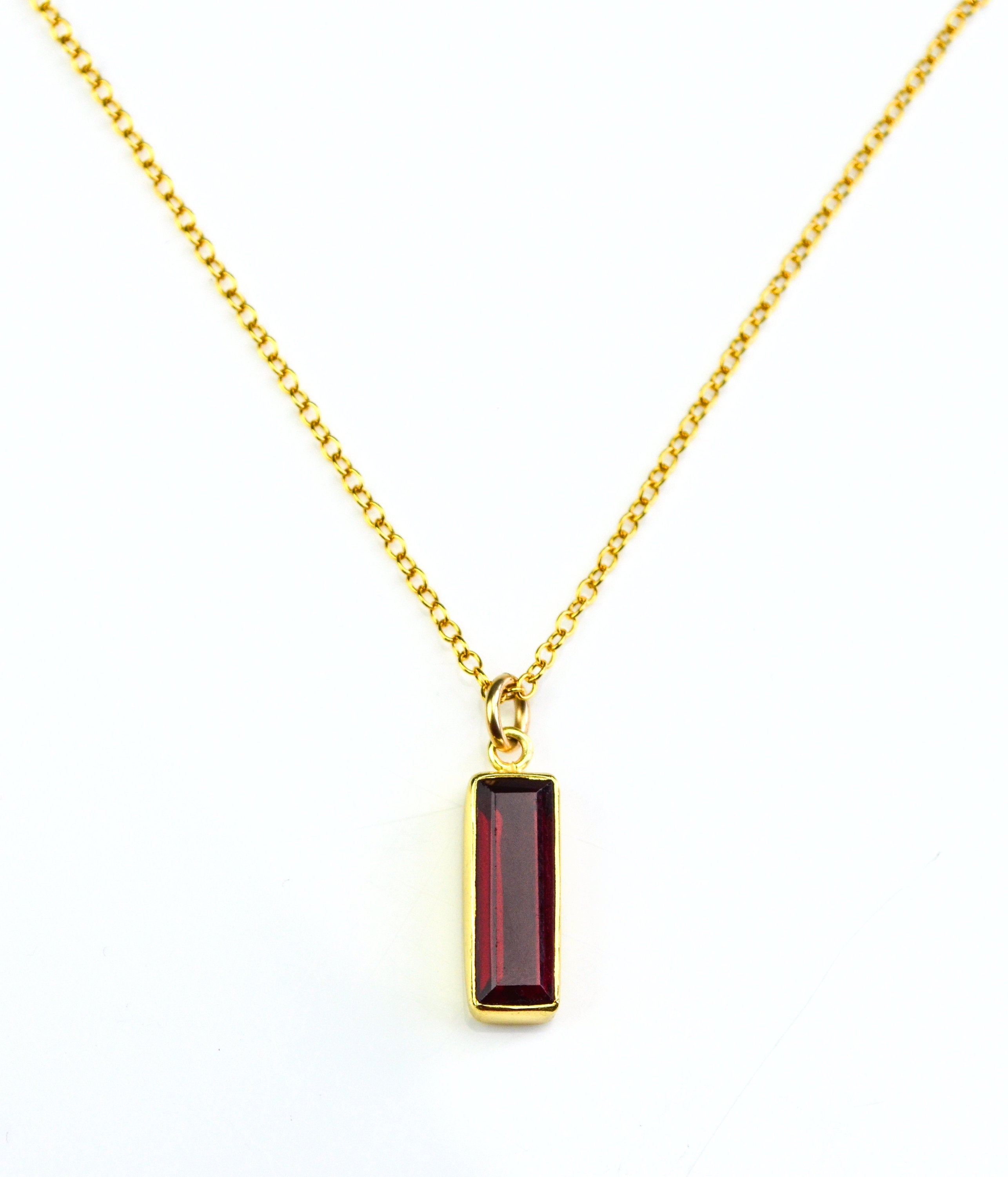 Single gold filled cable chain vertical garnet quartz january birthstone adira bar necklace on white background