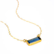 Single gold filled cable chain with horizontal september kyanite birthstone bar with secret message engraved on bottom on white background