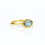 a gold labradorite ring shown on white background. stackable! Stacking rings, bezel set, small oval, tiny oval, dainty oval, birthstone rings, sterling silver stamp, birthstone ring, birthstone jewelry, iridescent gemstone, gray birthstone