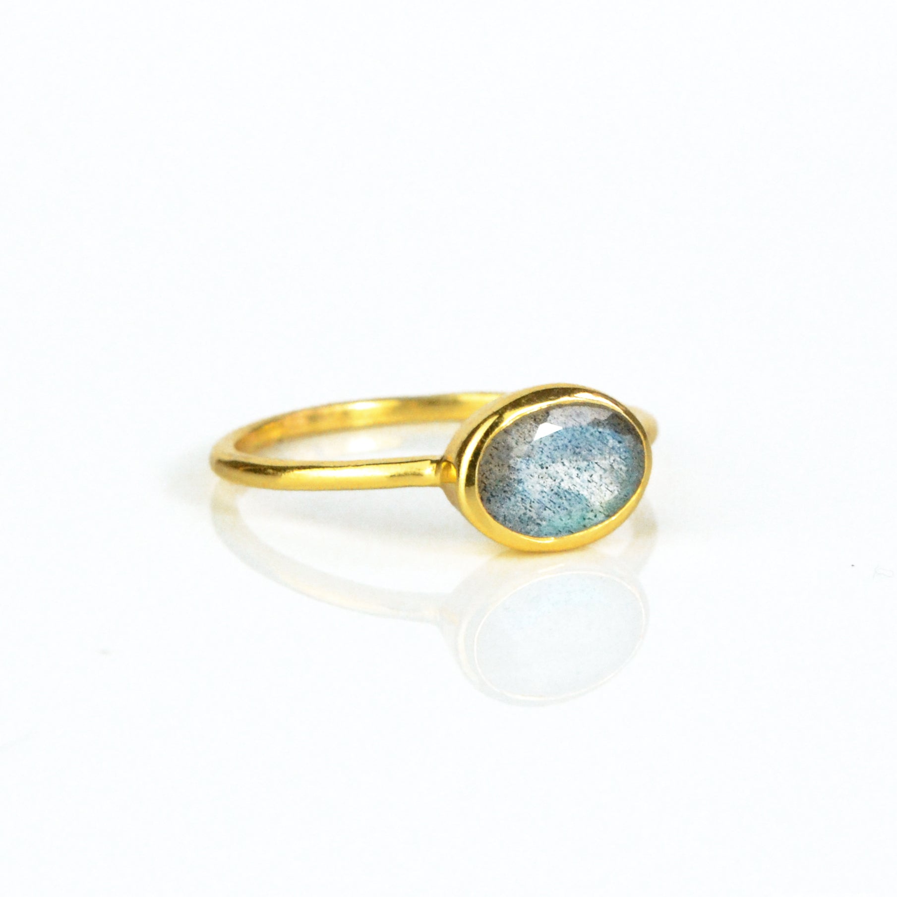 a gold labradorite ring shown on white background. stackable! Stacking rings, bezel set, small oval, tiny oval, dainty oval, birthstone rings, sterling silver stamp, birthstone ring, birthstone jewelry, iridescent gemstone, gray birthstone