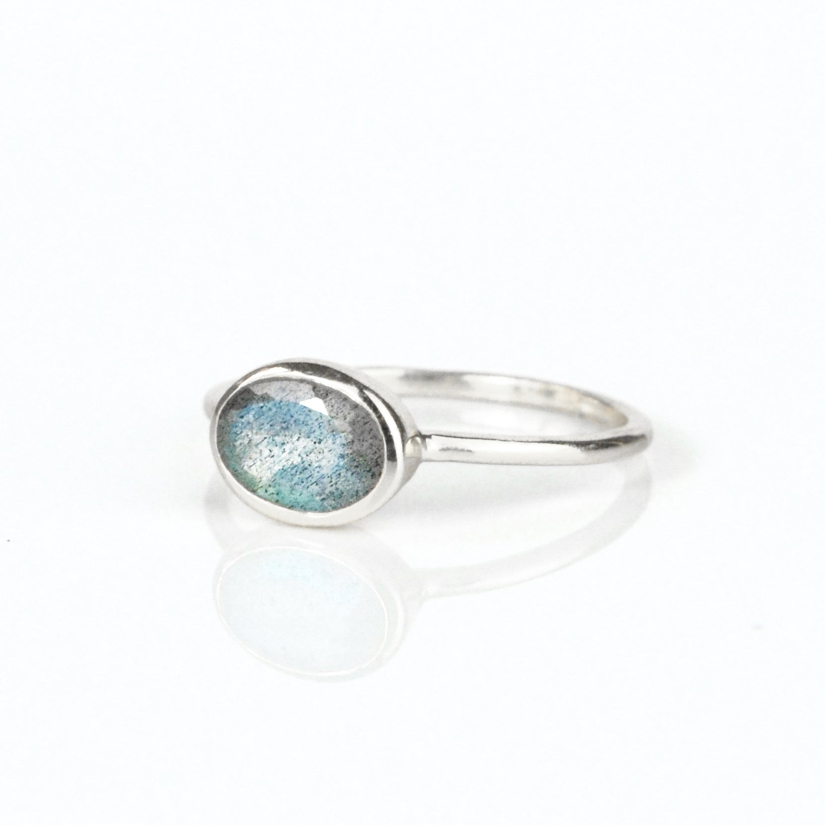 a sterling silver labradorite ring shown on white background. stackable! Stacking rings, bezel set, small oval, tiny oval, dainty oval, birthstone rings, sterling silver stamp, birthstone ring, birthstone jewelry, iridescent gemstone, gray birthstone