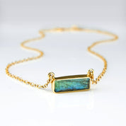 Horizontal gold filled cable labradorite gemstone bar adira series necklace on white background