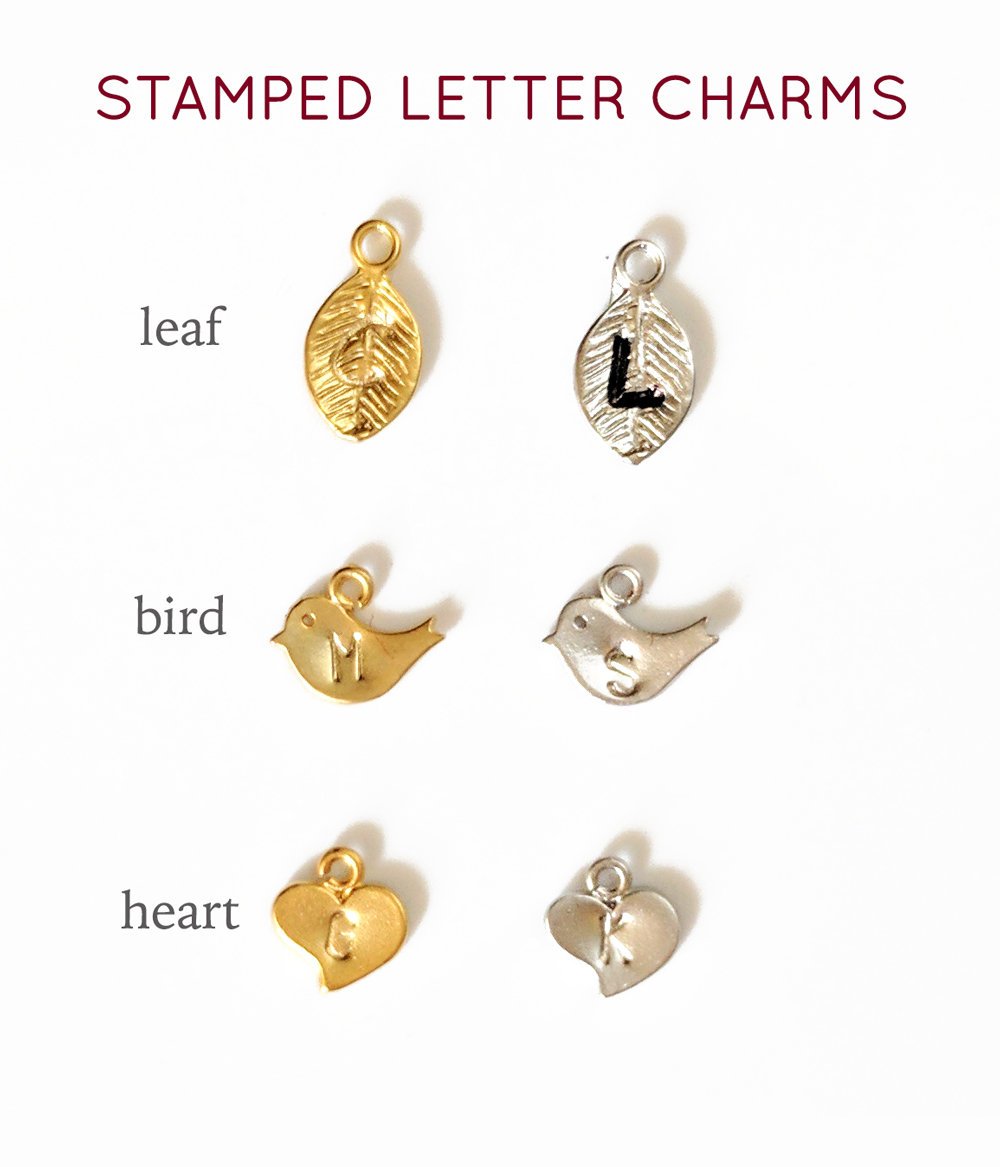 Hand stamped initial letter charms choose from leaf, baby bird or heart.