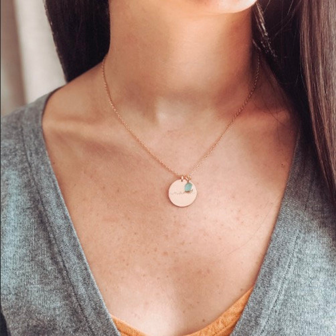 Model is wearing a single Rose gold filled mama design necklace with green amethyst birthstone.