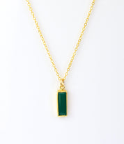Single gold filled cable chain with green tourmaline may birthstone on white background