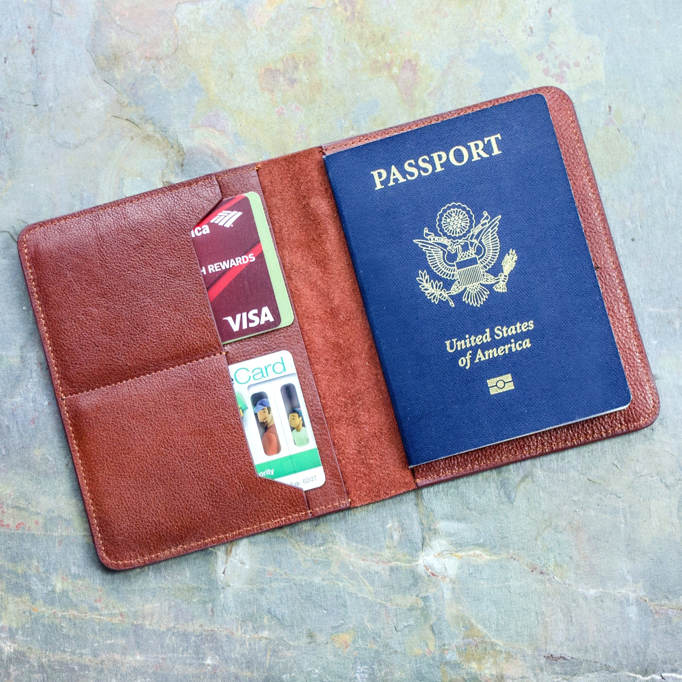 Red Brown High Quality Leather Passport Holder open flat with Two Card Pockets for ID Cards and a pocket holding a United States Passport