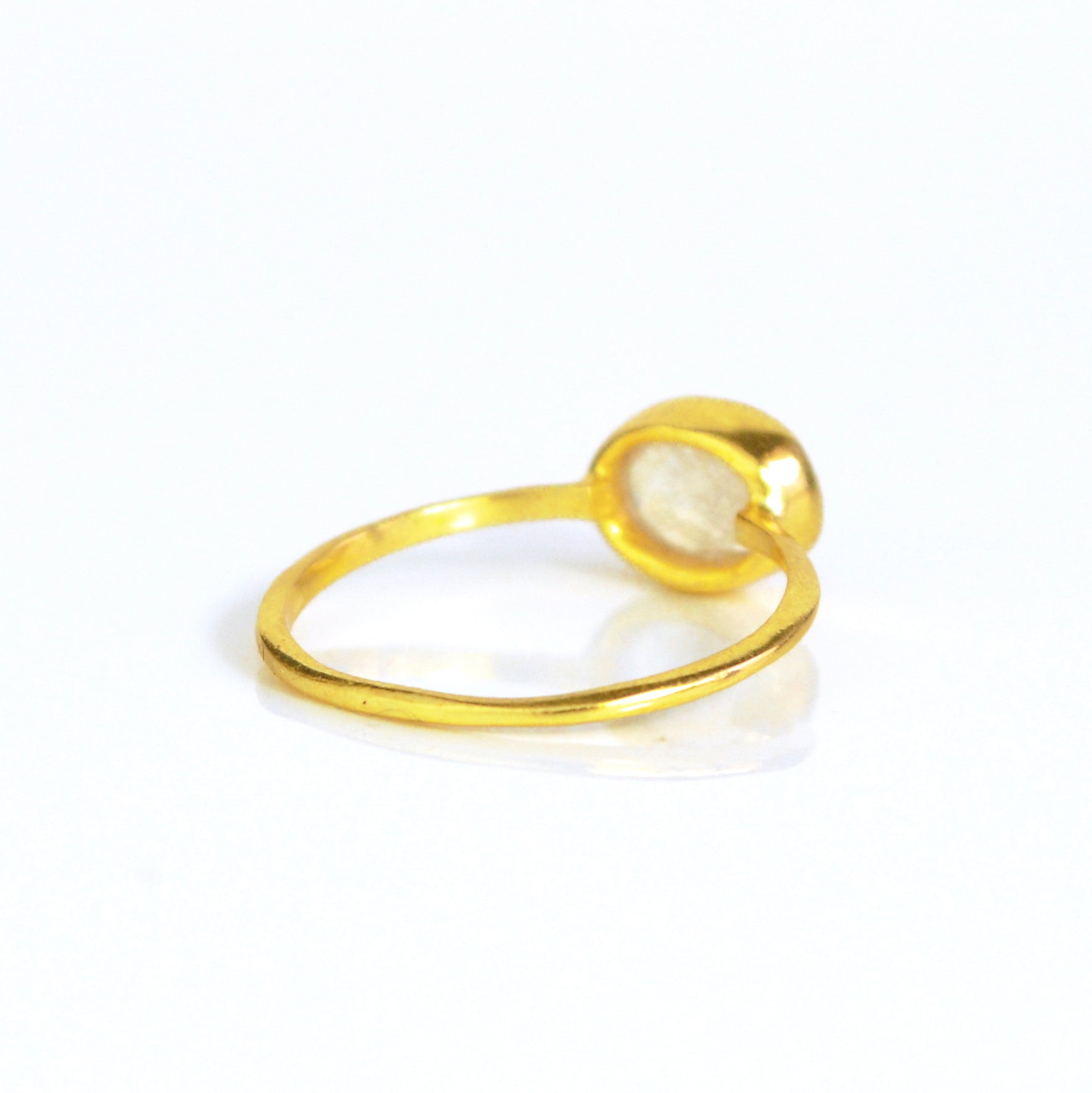 rear view of a gold rainbow moonstone ring shown on white background. stackable! Stacking rings, bezel set, small oval, tiny oval, dainty oval, birthstone rings, sterling silver stamp, birthstone ring, birthstone jewelry, white iridescent gemstone, moonstone birthstone, june birthstone, june gemstone, stack set, stacking rings, gemstone ring, birthstone ring, mother's day gift for her, gift for mom, christmas gift for girlfriend, wedding jewelry, bridesmaid jewelry, anniversary jewelry, anniversary gift