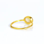 rear view of a gold rainbow moonstone ring shown on white background. stackable! Stacking rings, bezel set, small oval, tiny oval, dainty oval, birthstone rings, sterling silver stamp, birthstone ring, birthstone jewelry, white iridescent gemstone, moonstone birthstone, june birthstone, june gemstone, stack set, stacking rings, gemstone ring, birthstone ring, mother's day gift for her, gift for mom, christmas gift for girlfriend, wedding jewelry, bridesmaid jewelry, anniversary jewelry, anniversary gift
