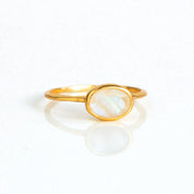 a rose gold rainbow moonstone ring shown on white background. stackable! Stacking rings, bezel set, small oval, tiny oval, dainty oval, birthstone rings, sterling silver stamp, birthstone ring, birthstone jewelry, white iridescent gemstone, moonstone birthstone, june birthstone, june gemstone, stack set, stacking rings, gemstone ring, birthstone ring, mother's day gift for her, gift for mom, wedding jewelry, bridesmaid jewelry, anniversary jewelry, anniversary gift, birthday gift, christmas gift