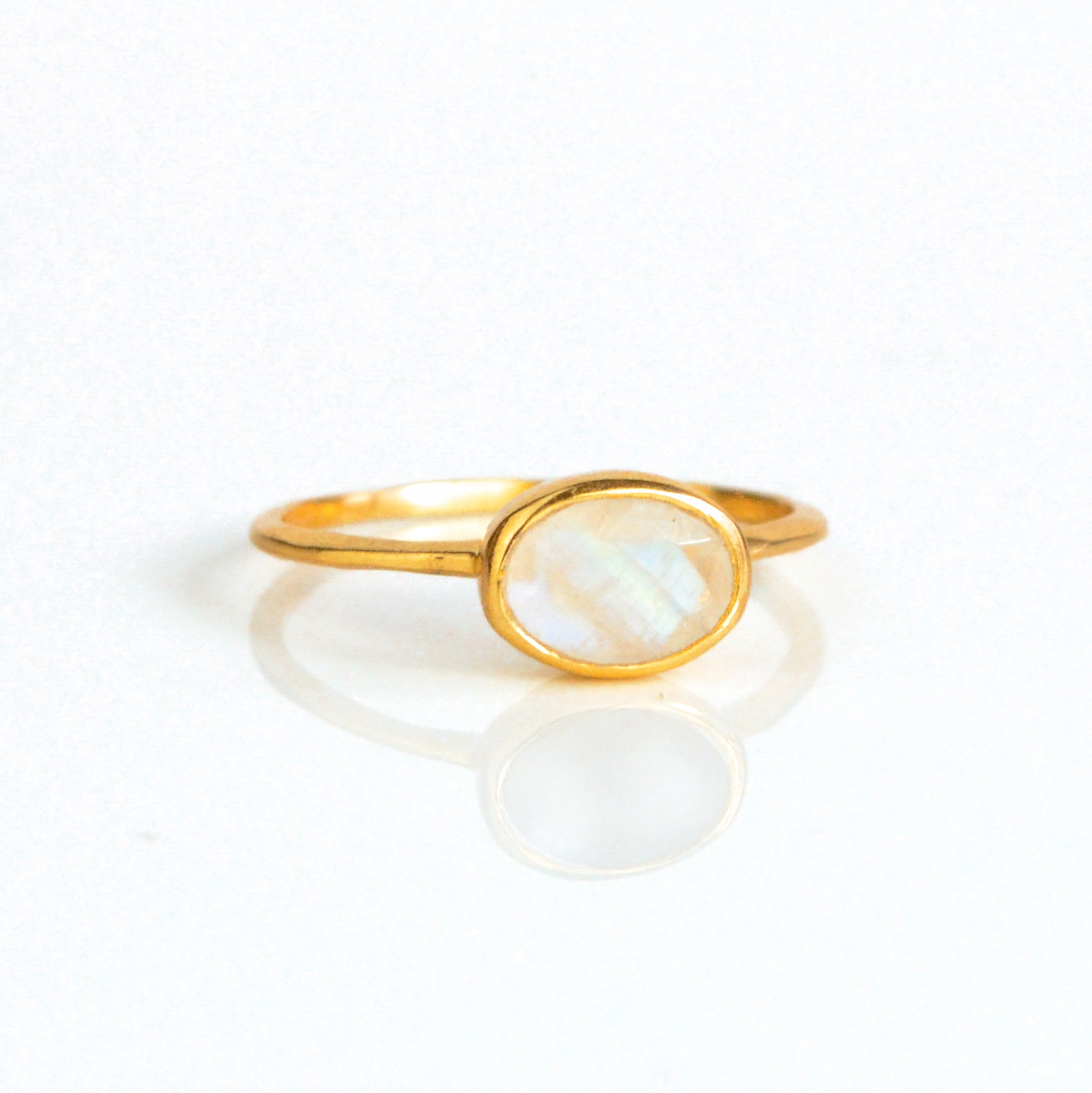 a rose gold rainbow moonstone ring shown on white background. stackable! Stacking rings, bezel set, small oval, tiny oval, dainty oval, birthstone rings, sterling silver stamp, birthstone ring, birthstone jewelry, white iridescent gemstone, moonstone birthstone, june birthstone, june gemstone, stack set, stacking rings, gemstone ring, birthstone ring, mother's day gift for her, gift for mom, wedding jewelry, bridesmaid jewelry, anniversary jewelry, anniversary gift, birthday gift, christmas gift