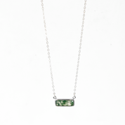 Single sterling silver cable chain with horizontal moss agate adira bar necklace on white background