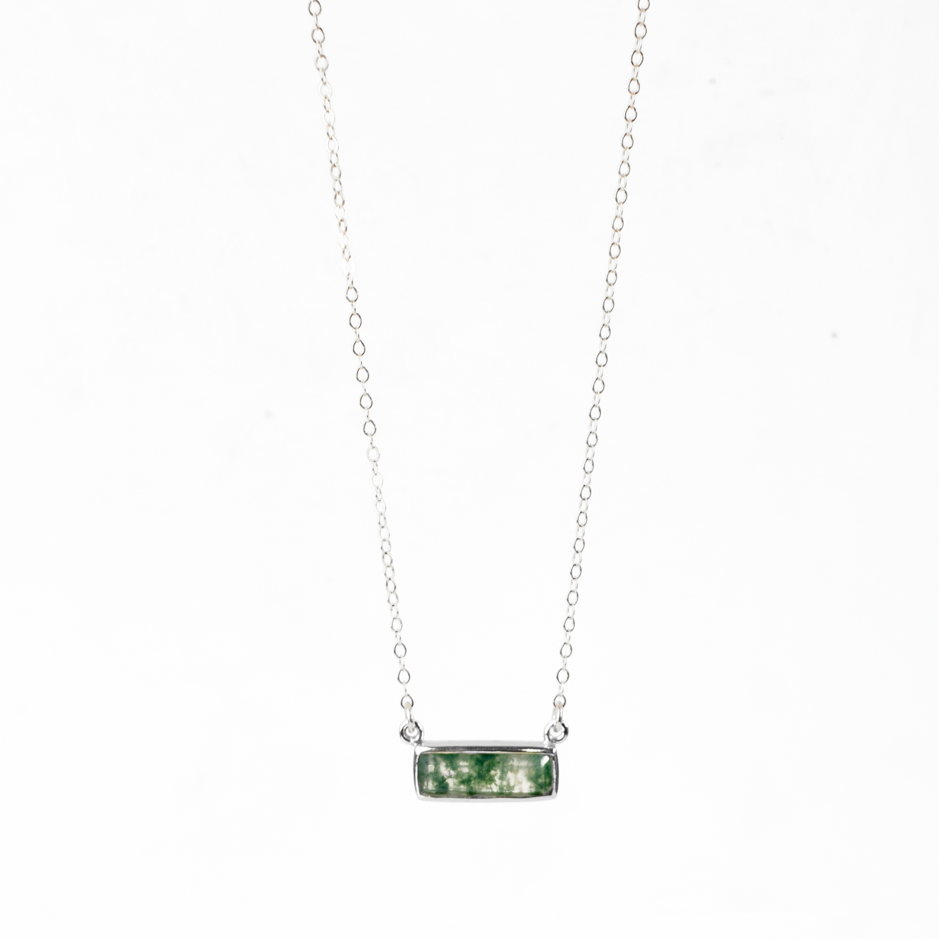 Single sterling silver cable chain with horizontal moss agate adira bar necklace on white background