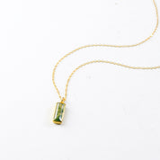 Single gold filled cable chain with vertical moss agate adira bar necklace on white background