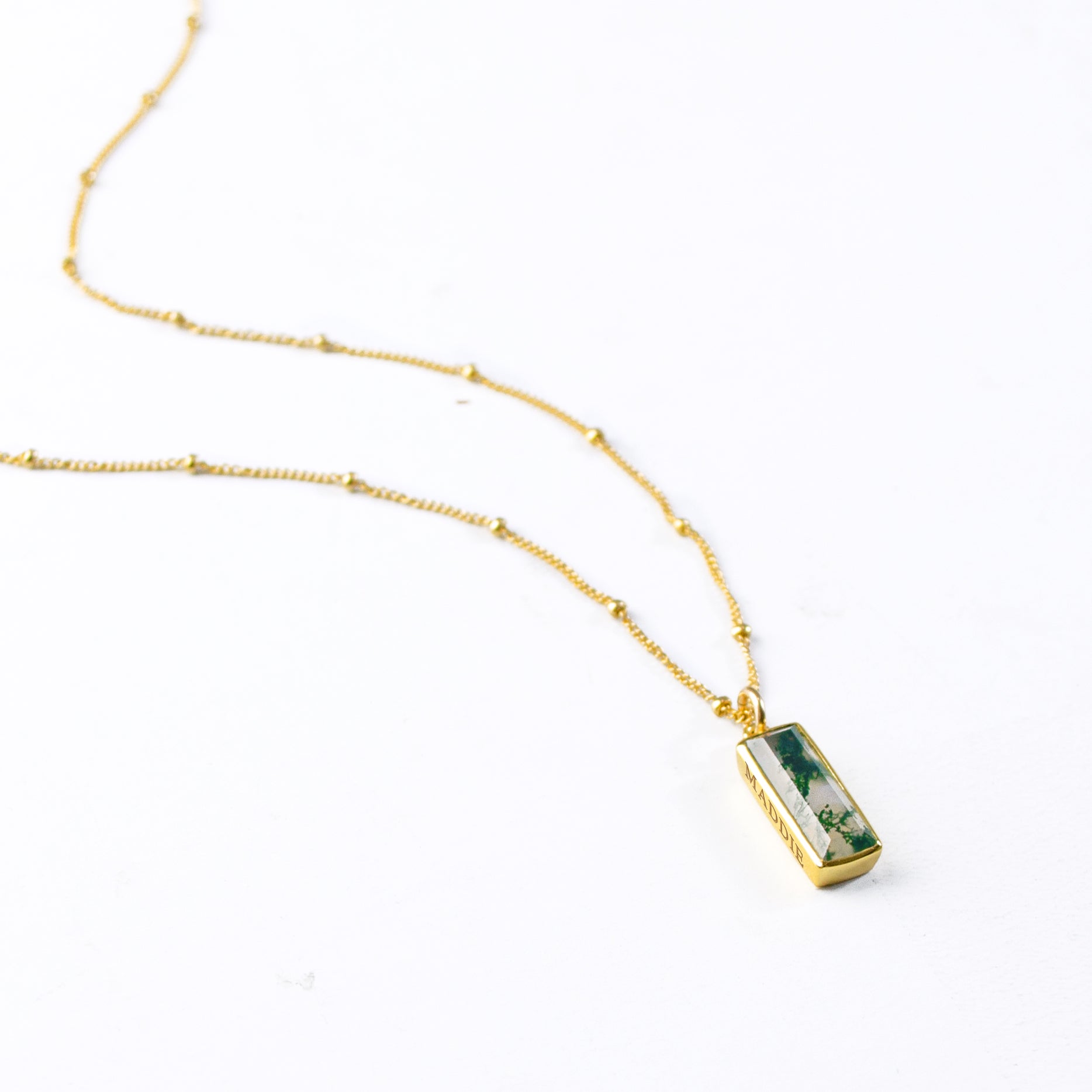 Single gold filled satellite chain with vertical moss agate adira bar necklace with secret engraving in our classic font on white background