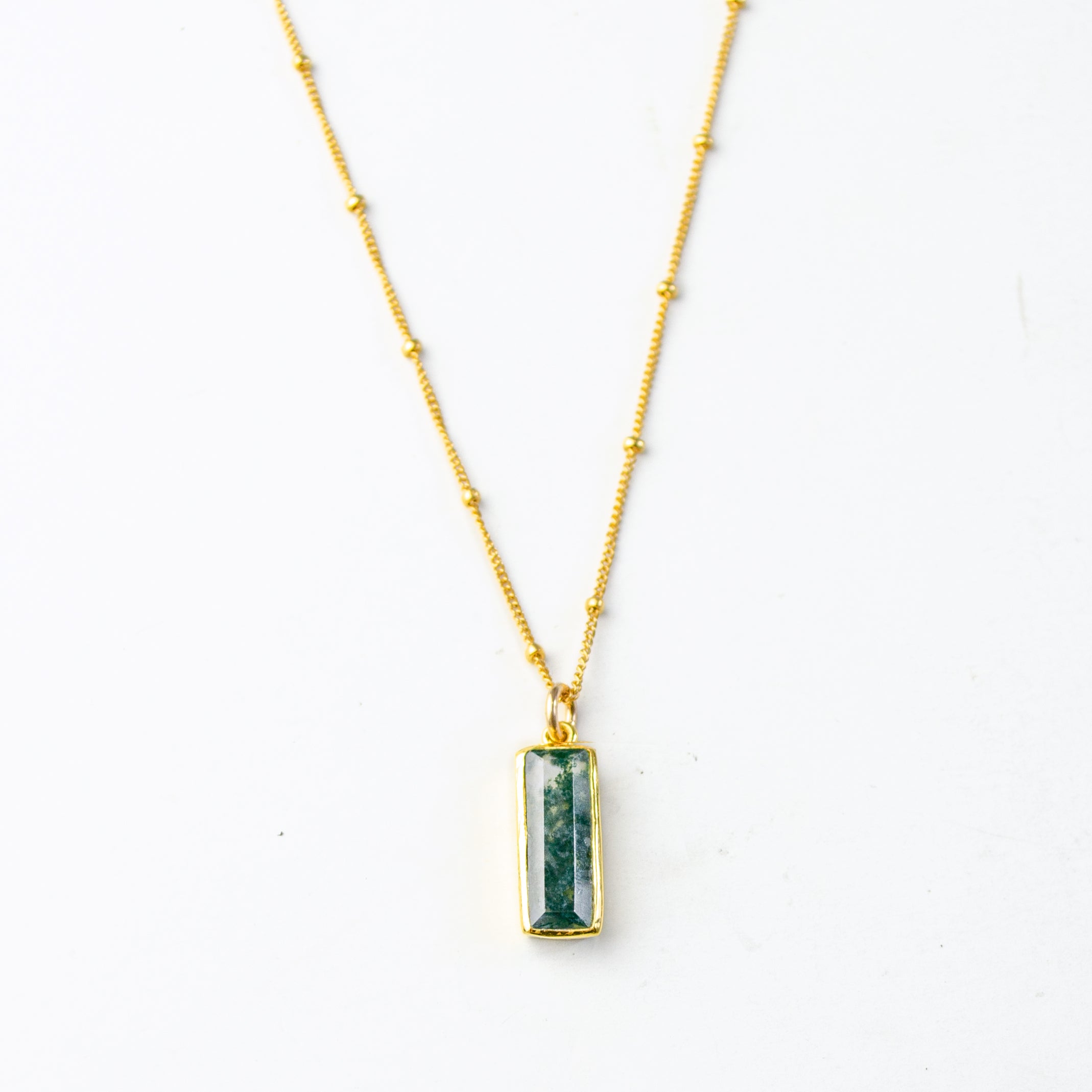 Single gold filled satellite chain with vertical moss agate adira bar necklace on white background