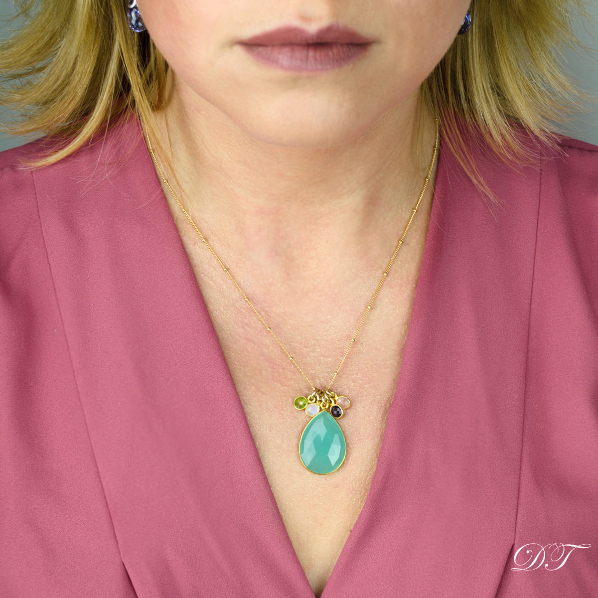 Model in pink top is wearing the mother's birthstone gold filled satellite necklace with 1 large aqua chalcedony stone and four tiny round peridot, moonstone, purple amethyst and pink chalcedony birthstones. 