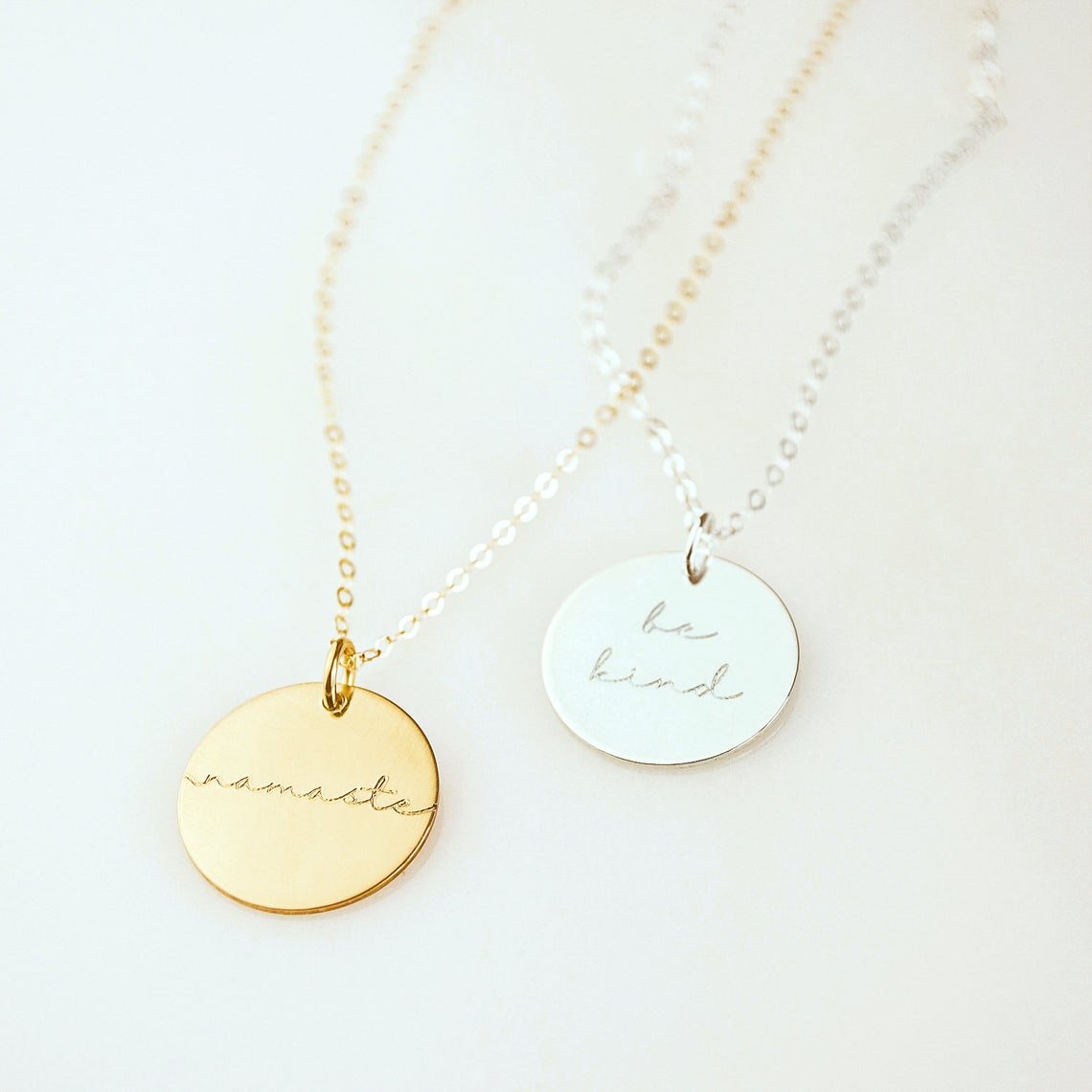 Custom engraved inspiration disc necklaces in gold, silver, and rose gold with words like be kind and loved, dainty motivational jewelry gift for her.