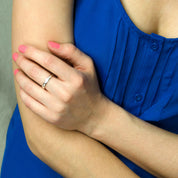 A person in a blue shirt wears an engraved ring on their middle finger. 4mm engraved band, personalized fingerprint jewelry, sterling silver ring, gold thin band, rose gold custom ring, special dates, coordinates engraving, name ring, cherished keepsake, engraved from photos, gift for loved one, modern style, available US sizes 4-13