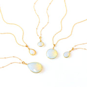 Elegant opalite gemstone necklaces in gold with faceted round and teardrop pendants, glowing with soft iridescent color. Handmade opal jewelry symbolizing creativity and balance, perfect minimalist necklace for layering or gifting. October birthstone jewelry for women available in multiple pendant sizes and finishes, a delicate gemstone necklace ideal for birthdays, anniversaries, or thoughtful everyday wear.