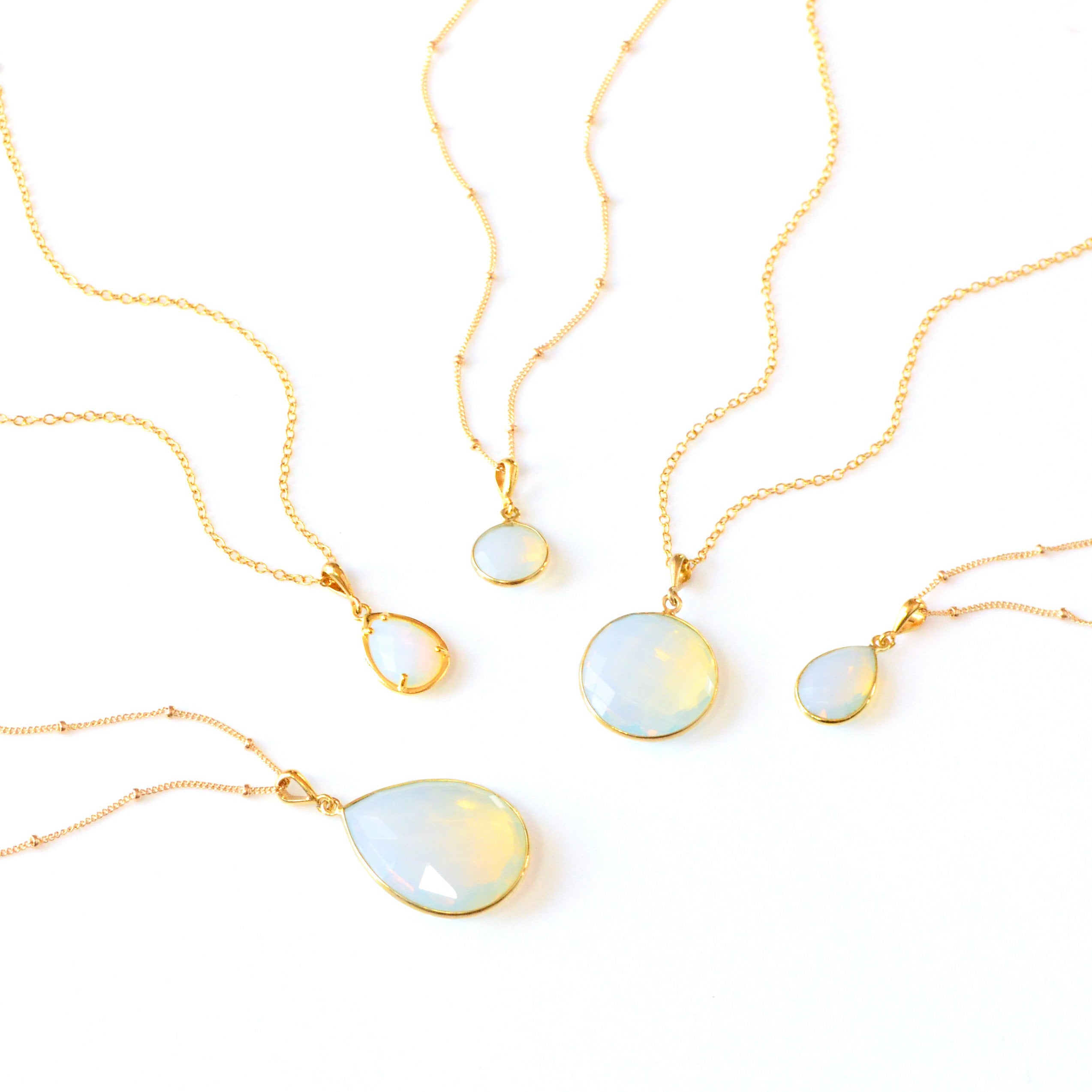 Elegant opalite gemstone necklaces in gold with faceted round and teardrop pendants, glowing with soft iridescent color. Handmade opal jewelry symbolizing creativity and balance, perfect minimalist necklace for layering or gifting. October birthstone jewelry for women available in multiple pendant sizes and finishes, a delicate gemstone necklace ideal for birthdays, anniversaries, or thoughtful everyday wear.