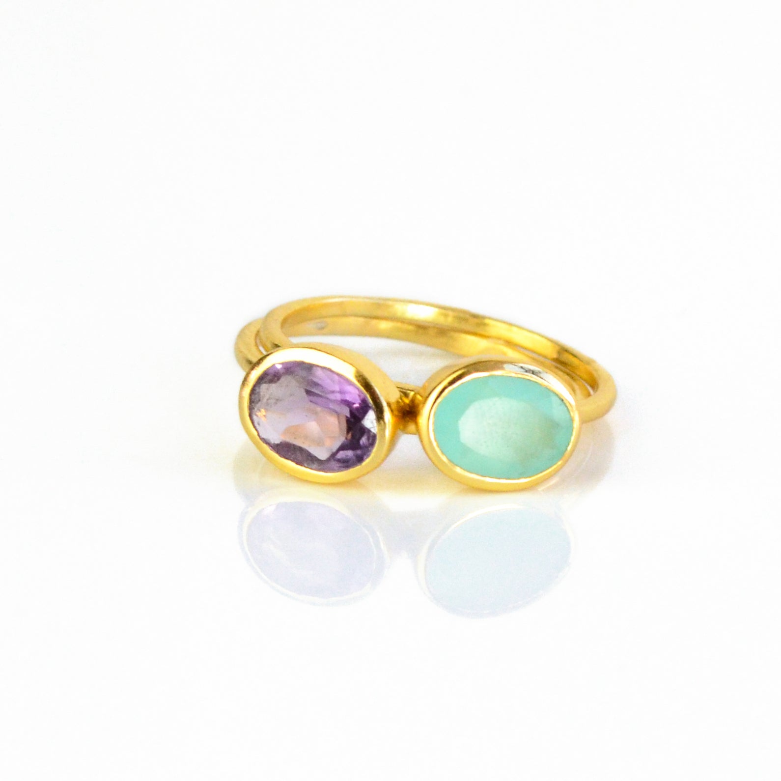 a gold aqua chalcedony ring with purple amethyst shown on white background. Stacking rings, bezel set, small oval, tiny oval, dainty oval, birthstone rings, sterling silver stamp, birthstone ring, birthstone jewelry, march birthstone, march gemstone, stack set, stacking rings, gemstone ring, birthstone ring, mother's day gift for her, gift for mom, gift for fiance, gift for girlfriend, wedding jewelry, bridesmaid jewelry, anniversary jewelry, anniversary gift, birthday gift, christmas gift, valentine's day 