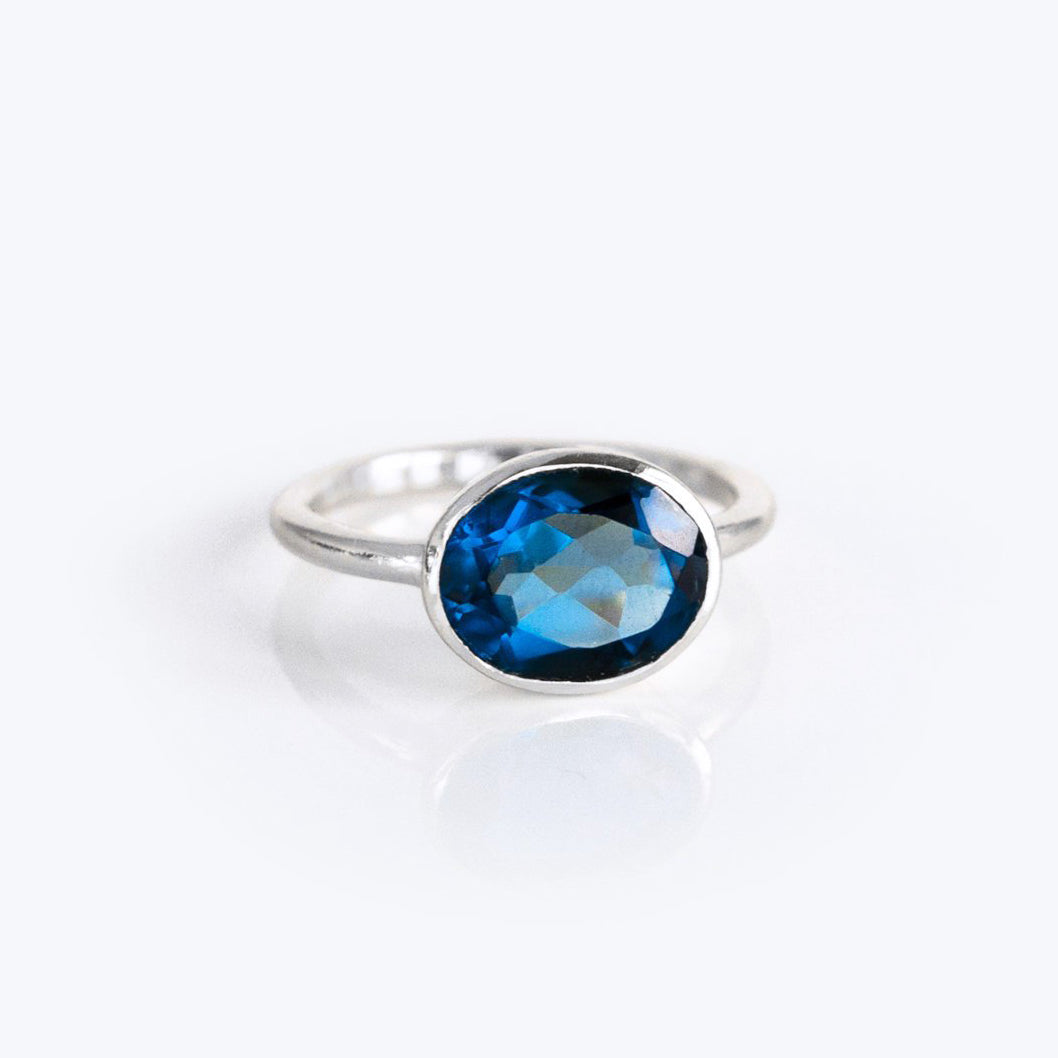 Sterling silver kyanite ring featuring an oval, sapphire-blue faceted stone in a sleek bezel setting; modern minimalist profile ideal for stacking; durable .925 band, hypoallergenic, and a chic September birthstone alternative to sapphire.