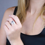 Model wearing custom engraved sterling silver paw print ring.