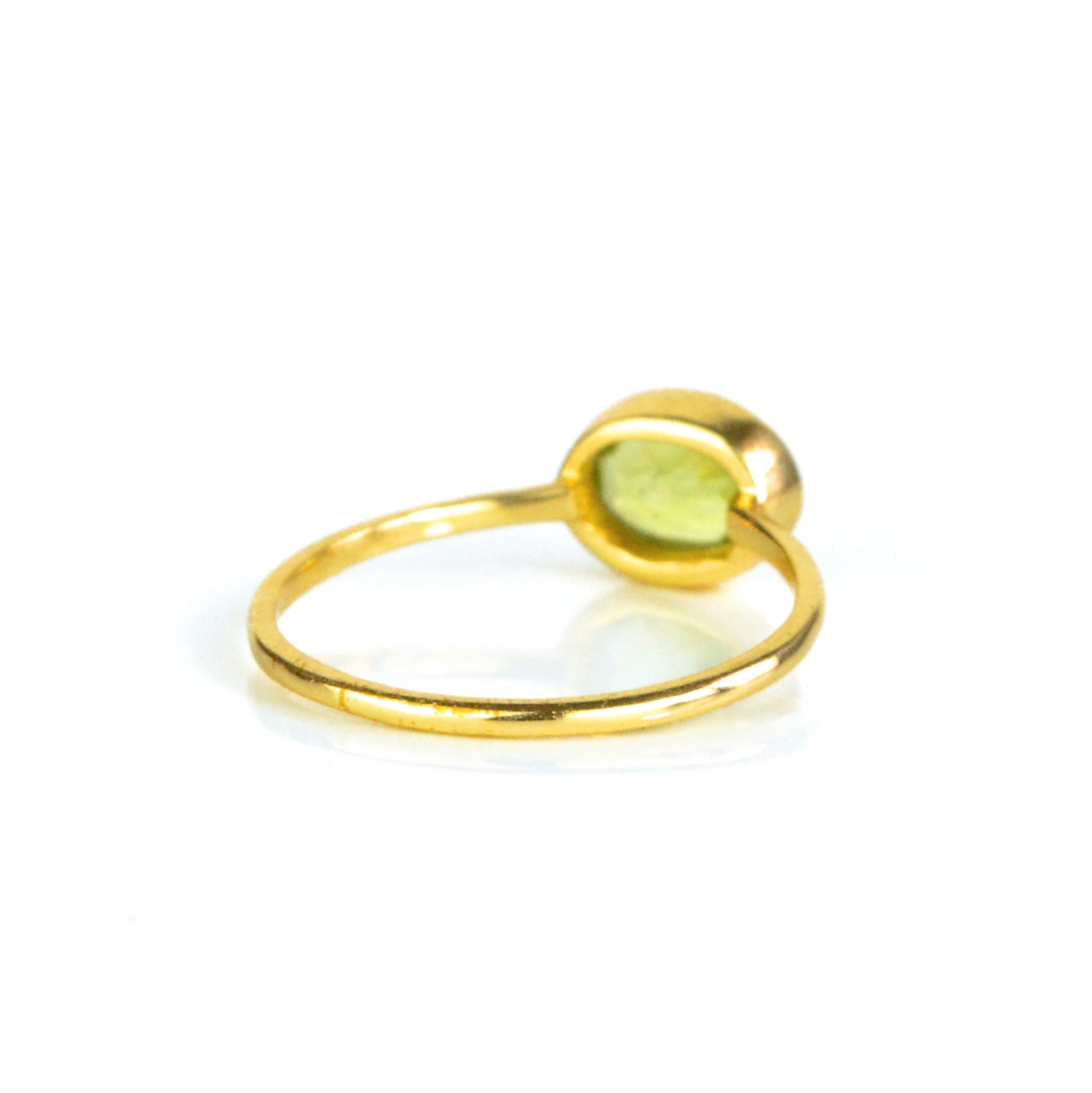 rear view of a gold peridot ring shown on white background. stackable! Stacking rings, bezel set, small oval, tiny oval, dainty oval, birthstone rings, sterling silver stamp, birthstone ring, birthstone jewelry, green gemstone, peridot birthstone, august birthstone, august gemstone, birthstone jewelry, august birthstone, august birthday, green ring, peridot birthstone. stack set, stacking rings, gemstone ring, birthstone ring, mother's day gift for her, gift for mom, gift for fiance, gift for girlfriend