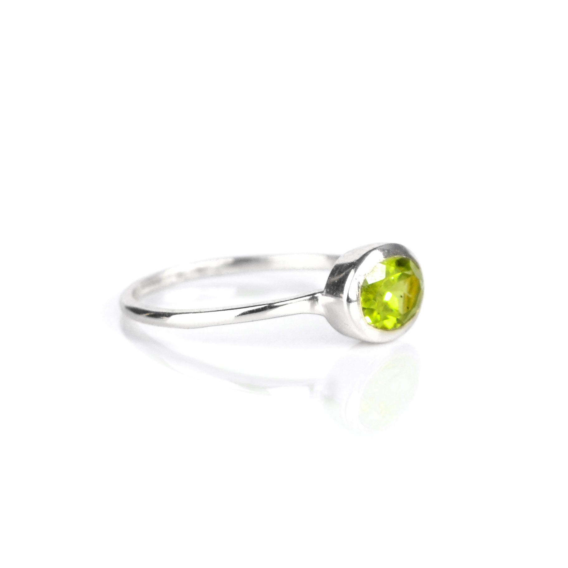 a sterling silver peridot ring shown on white background. stackable! Stacking rings, bezel set, small oval, tiny oval, dainty oval, birthstone rings, sterling silver stamp, birthstone ring, birthstone jewelry, green gemstone, peridot birthstone, august birthstone, august gemstone