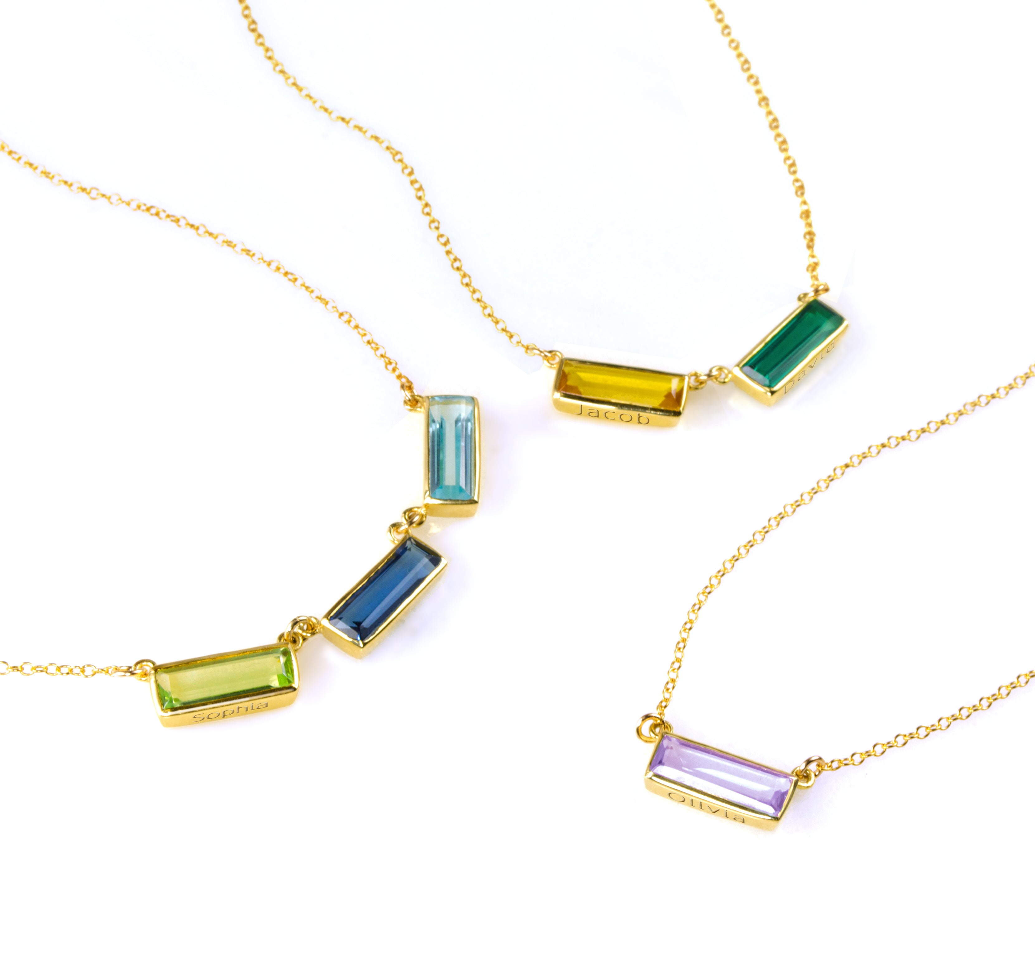 Personalized baguette-cut birthstone bar necklaces in sterling silver, gold filled, and rose gold, each with rectangular bezel settings. Customize with engraved names or secret messages to create a sentimental birthstone jewelry gift for mom or grandmother. Choose from January Garnet, February Amethyst, March Aquamarine, May Emerald, July Ruby, September Sapphire, December Blue Topaz, and more to represent your family.