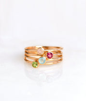 set of four rose gold plated dainty 3mm gemstone rings featuring pink chalcedony, ruby, aqua chalcedony and peridot. October birthstone. On white background. 925 sterling silver, birthstone ring, stacking ring, stackable, birthstone jewelry, facet gemstone