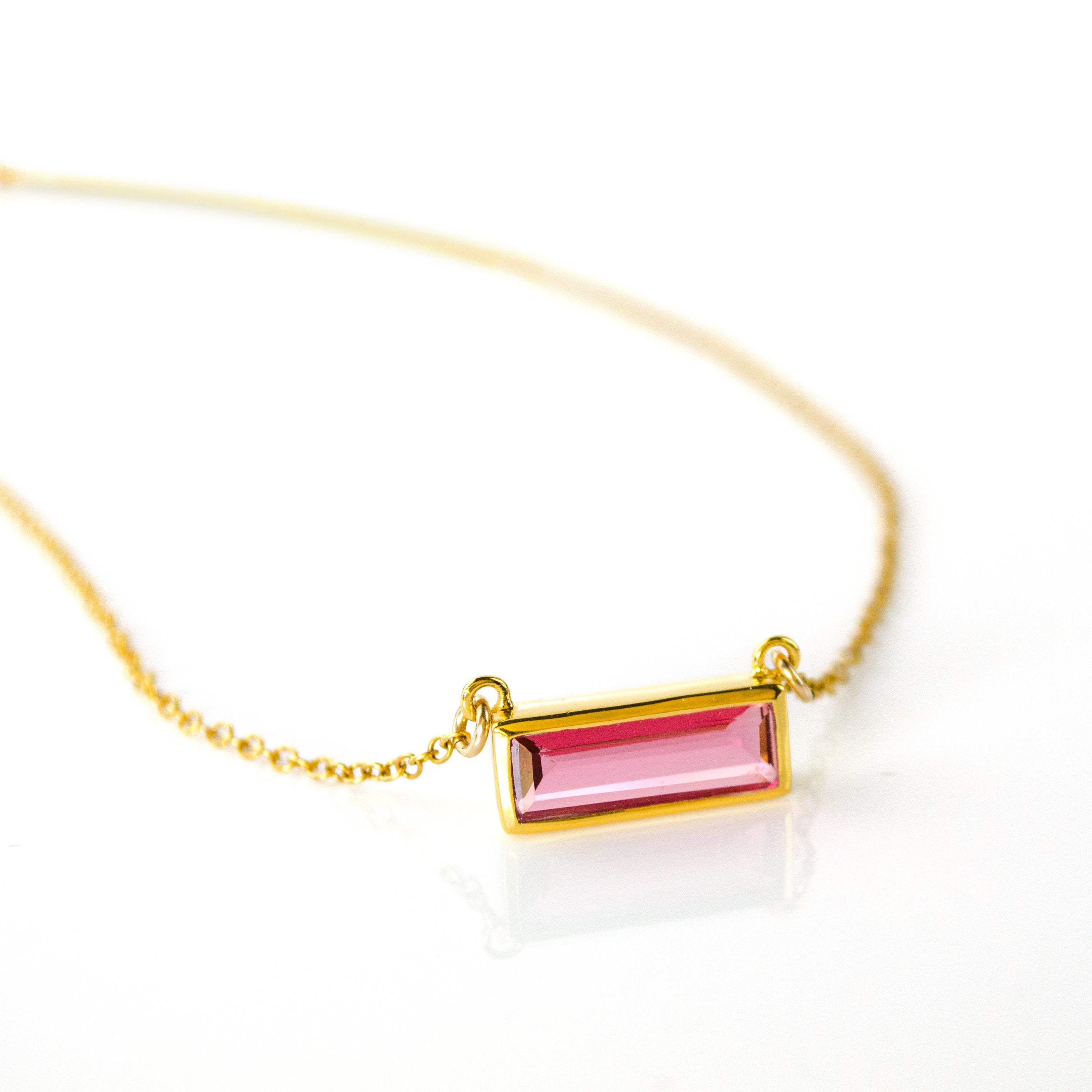Single gold filled cable chain with ruby quartz horizontal bar adira necklace july birthstone on white background