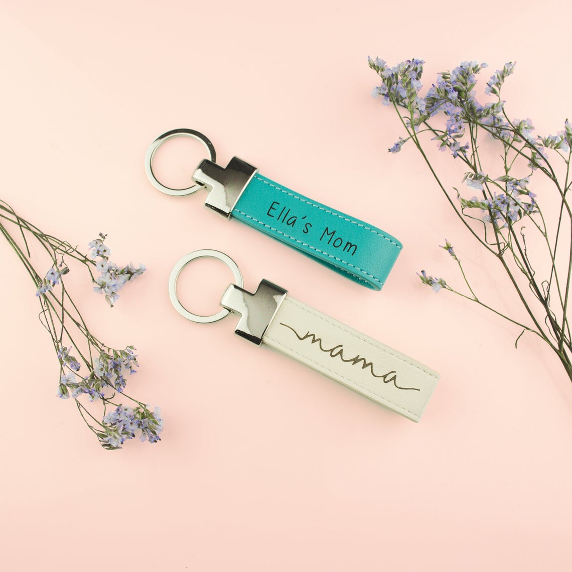 two custom leather keychains. Turquoise keyfob with Ella's Mom engraved. Nude keychain with our special mama design