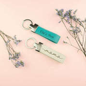 two custom leather keychains. Turquoise keyfob with Ella's Mom engraved. Nude keychain with our special mama design