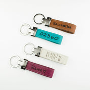 Four Personalized Engraved Genuine Leather Loop Keychains with stainless steel keychain loops. Brown Leather Keychain with custom engraved name, Turquoise Leather Loop Keychain with zipcode or custom numbers engraved, White Leather Loop Keychain with custom engraved coordinates, raspberry pink leather loop keychain engraved with name and a heart