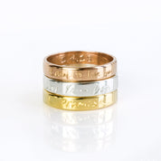 A stack of three rings in gold, silver and rose gold. Custom engraved band, fingerprint ring, 4mm thin jewelry, sterling silver ring, gold personalized band, rose gold accessory, names, dates, and coordinates, photo engraving option, heartfelt keepsake, timeless gift idea, modern design, sizes 4-13, elegant look