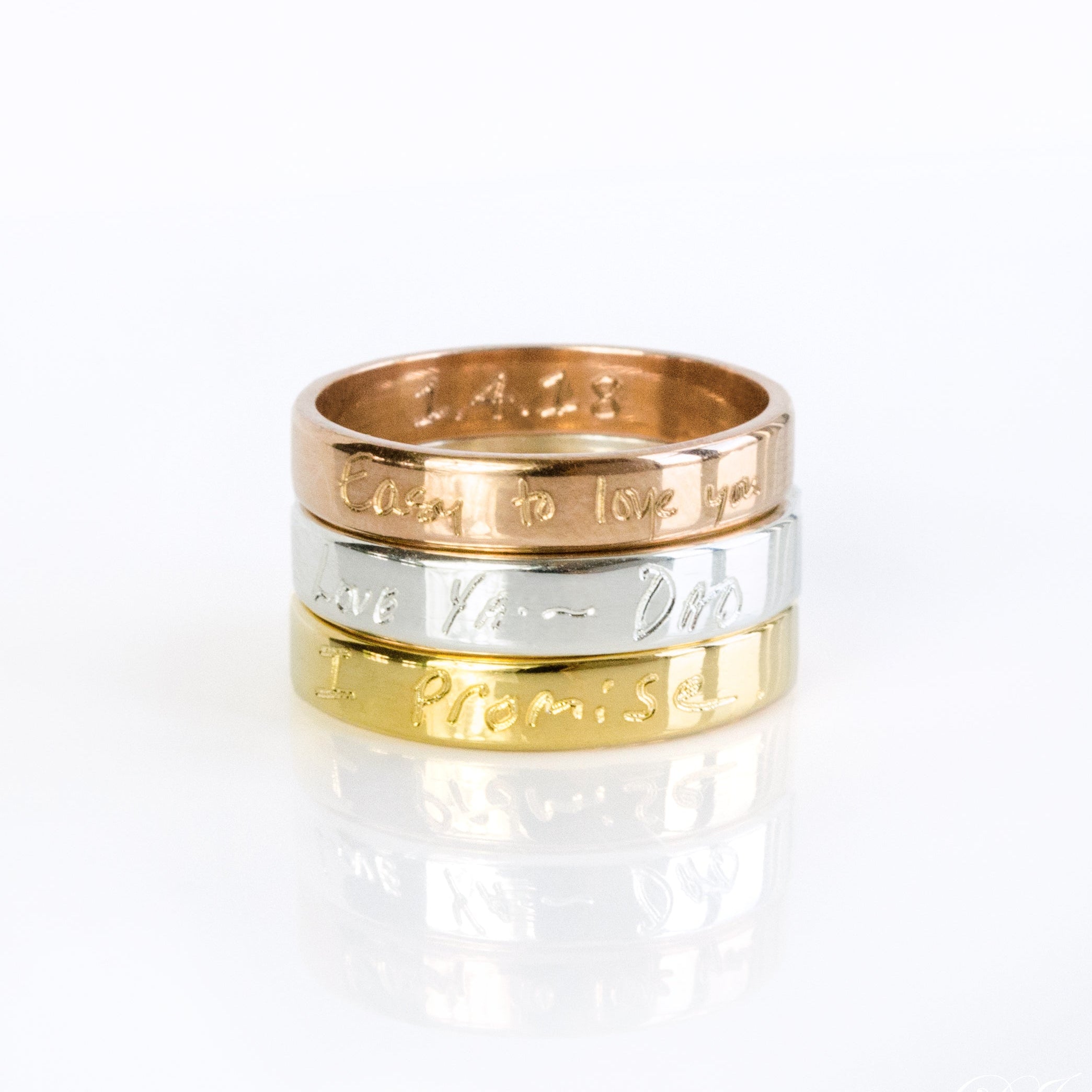 A stack of three rings in gold, silver and rose gold. Custom engraved band, fingerprint ring, 4mm thin jewelry, sterling silver ring, gold personalized band, rose gold accessory, names, dates, and coordinates, photo engraving option, heartfelt keepsake, timeless gift idea, modern design, sizes 4-13, elegant look