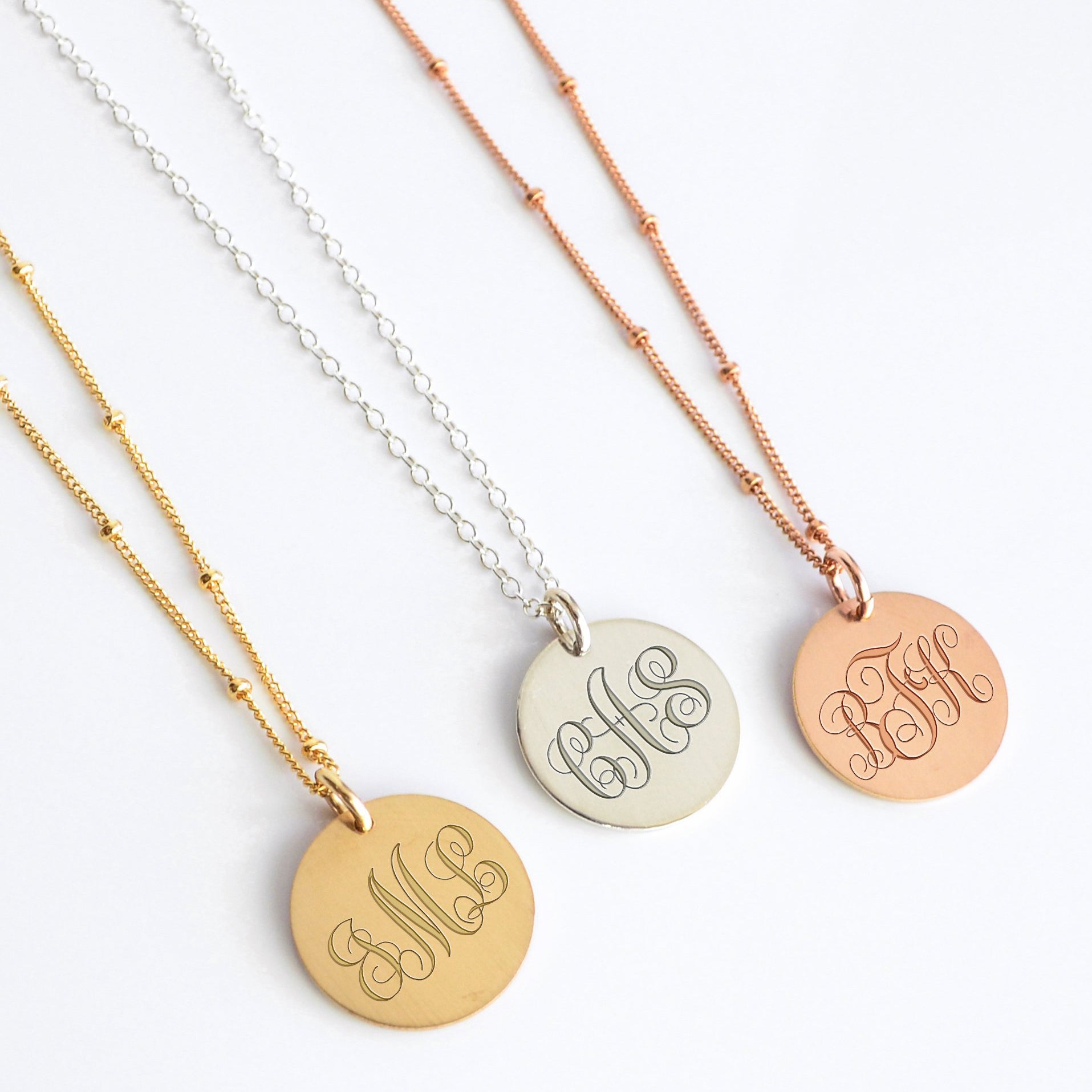 Gold silver and rose gold monogram disc necklaces with custom engraved initials, personalized round pendant jewelry gift