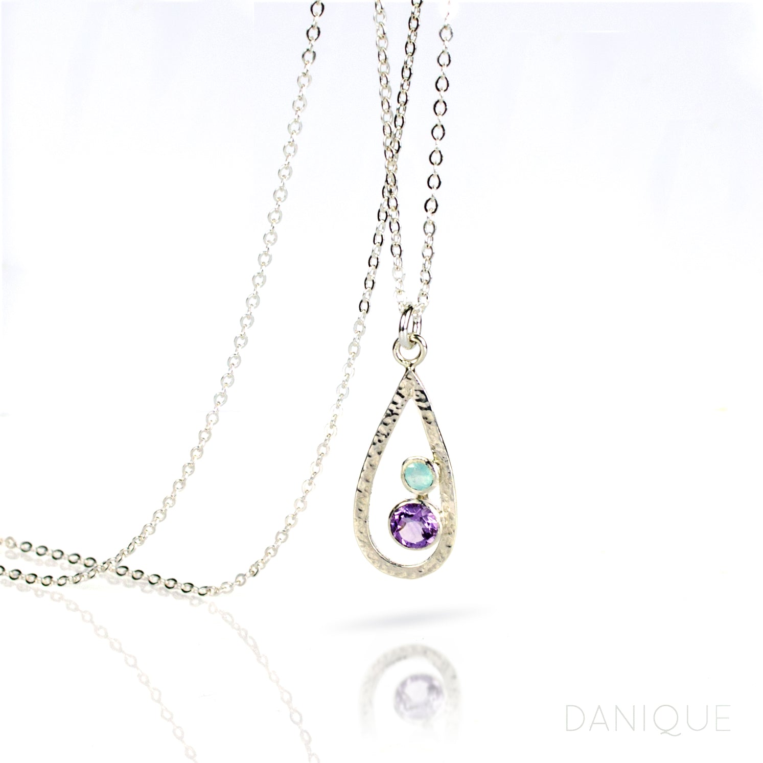 Single sterling silver teardrop frame birthstone necklace with 1 5mm purple amethyst stone and 1 3mm aqua chalcedony stone representing the child