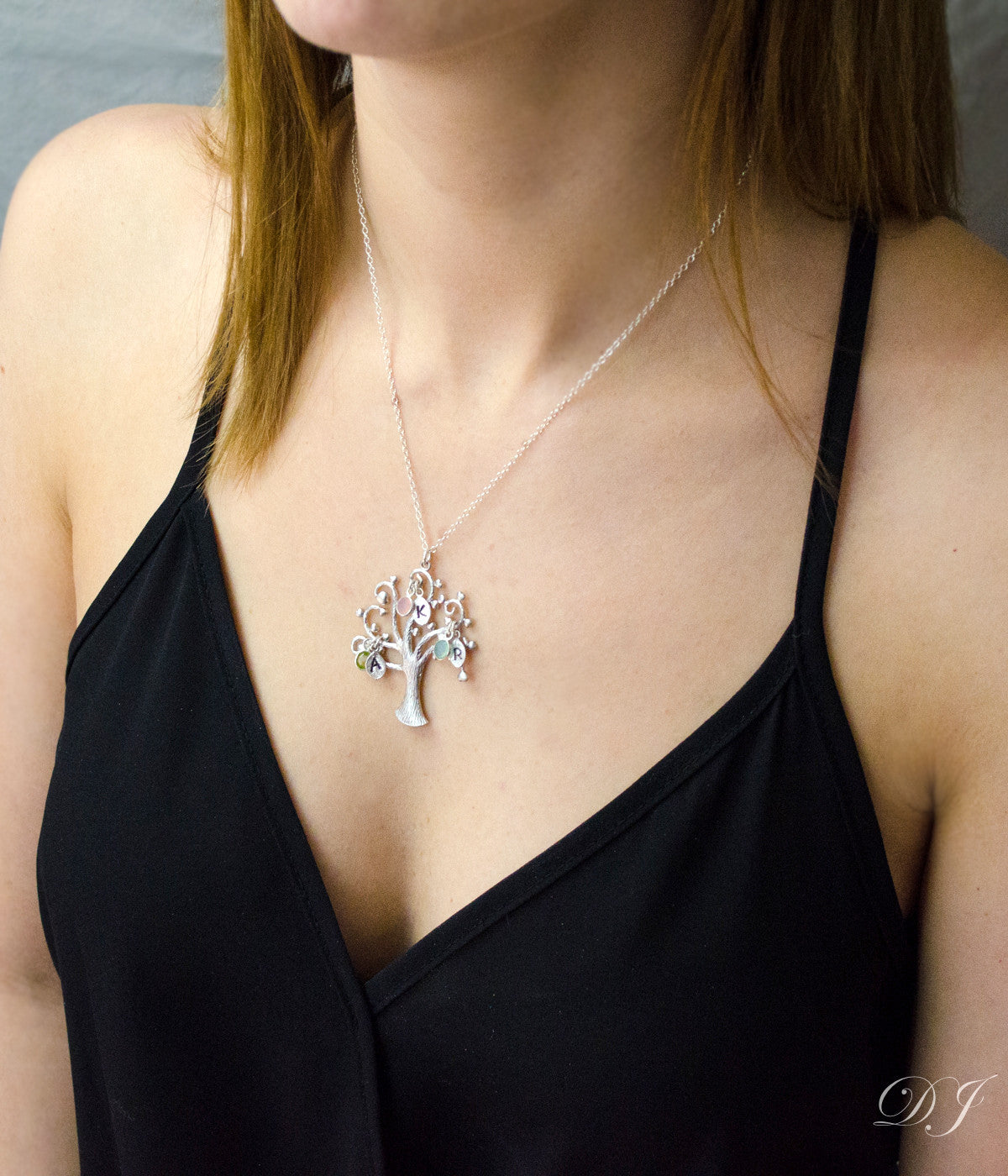 Model in black top is wearing our silver swirly tree necklace with hand stamped leaf charms and peridot, pink chalcedony and aqua chalcedony birthstones