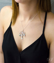 Model in black top is wearing our silver swirly tree necklace with hand stamped leaf charms and peridot, pink chalcedony and aqua chalcedony birthstones